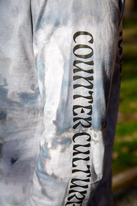 Photo of the sleeve of a tie dyed shirt that says, "Counter Culture."