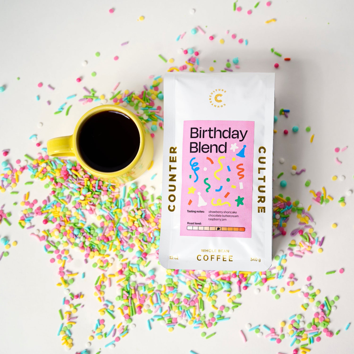 Counter Culture Coffee Birthday Blend package with a coffee cup and colorful sprinkles on a light background